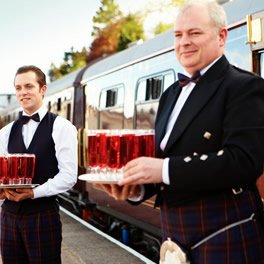 Belmond Royal Scotsman staff await passengers with refreshing drinks