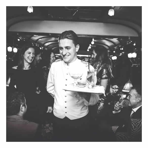 Waiter serving drinks in the Bar Car on board the Venice Simplon Orient Express